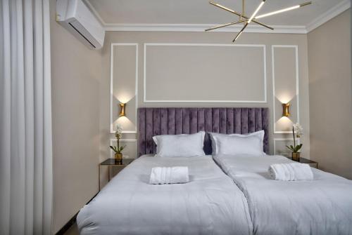 a bedroom with a large bed with two white pillows at Yourest HaAri - יורסט הארי in Safed