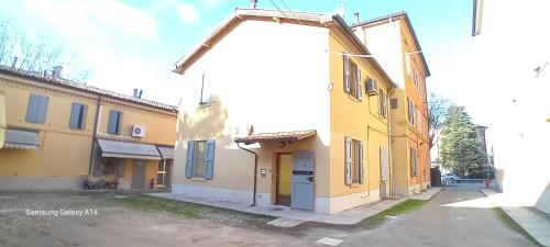 an empty parking lot in front of a yellow building at Panigale90 in Bologna