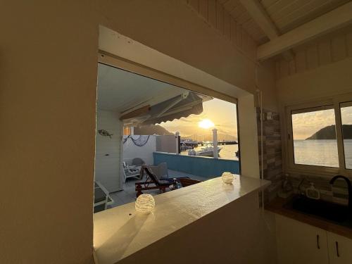 a view of a kitchen with a view of the ocean at KazParadis les Saintes in Terre-de-Haut