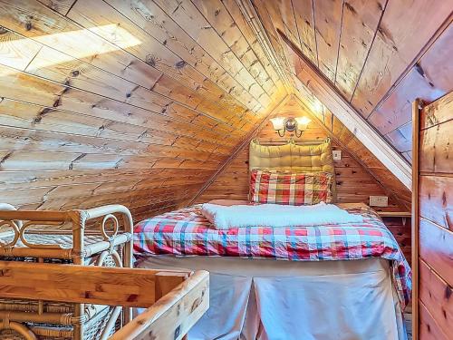 a bedroom with a bed in a wooden attic at Studio Eagle Nest by Interhome in Lettermacaward