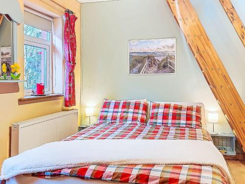 a bedroom with a bed and a window at Studio Eagle Nest by Interhome in Lettermacaward