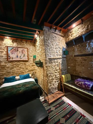 a room with a bed and a bench in it at Dar kenza Tunis in Tunis