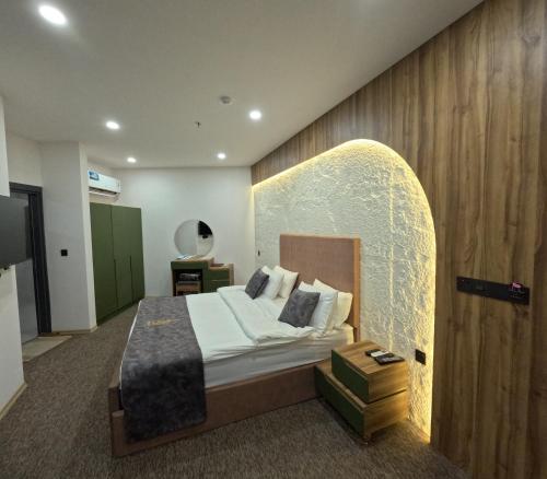 a hotel room with a bed with a surfboard on the wall at Abraj Al Madina Hotel in Al Fayşalīyah