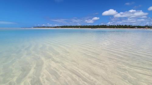 a large body of water with trees in the background at Casa Centro de Maragogi in Maragogi