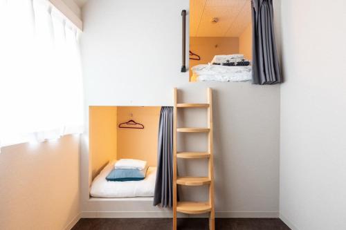 a small room with a bunk bed and a ladder at Sekine Building 4th floor - Vacation STAY 75338v in Tokyo