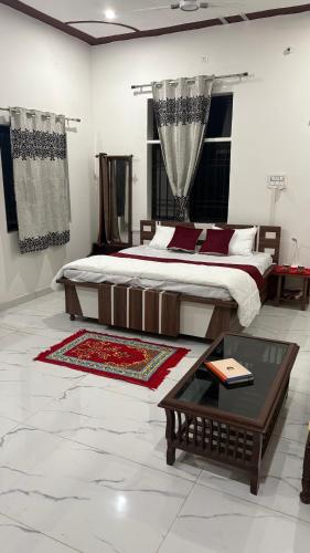 a bedroom with a king sized bed and a coffee table at The ROYAL OASIS in Khetri