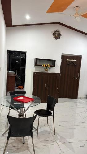 a dining room with a glass table and chairs at The ROYAL OASIS in Khetri