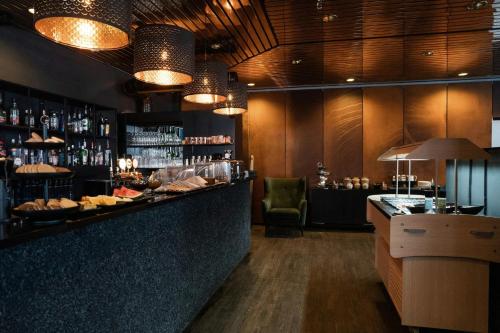 a bar in a restaurant with a counter with food at Hotel Vestmannaeyjar in Vestmannaeyjar