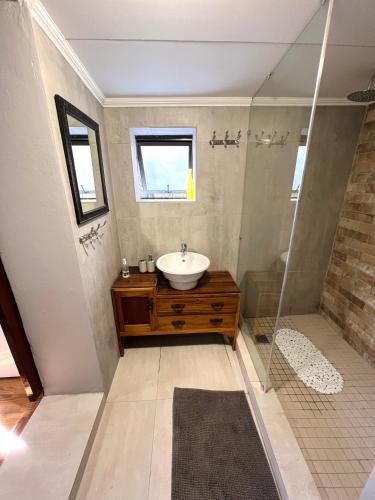 a bathroom with a sink and a shower at Mizpah Lodge in Bloemfontein