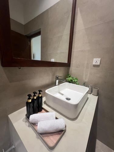 a bathroom with a white sink and a mirror at Lumiere Villa, Kandy in Nugawela