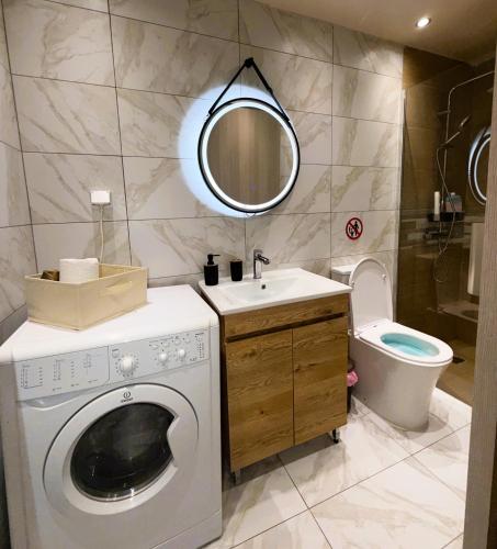 a bathroom with a washing machine and a sink at Central Piraeus port apartment in Piraeus
