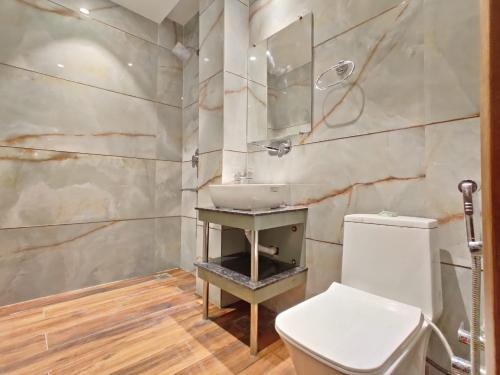 a bathroom with a sink and a toilet at Hotel Absolut Comfort 500 MTR FROM GOLDEN TEMPLE in Amritsar