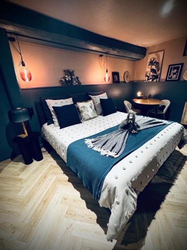a bedroom with a large bed with blue walls at Suite Richovilare - Sauna & Hammam in Riquewihr