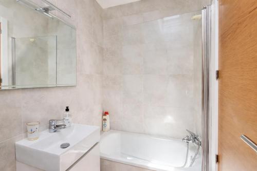 a white bathroom with a sink and a shower at El Rincon de las Americas in Colombres