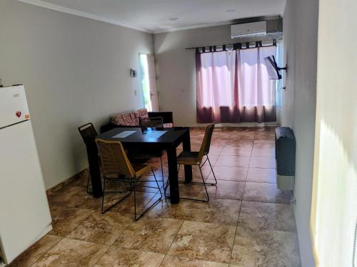 a kitchen and dining room with a table and chairs at Depto Civora 3 in Villa Regina