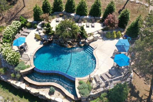 an overhead view of a swimming pool with chairs and umbrellas at The Bavarian Village Resort in Branson