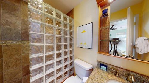 a bathroom with a toilet and a sink and a mirror at Bluff Condo 4015 in Sun Valley