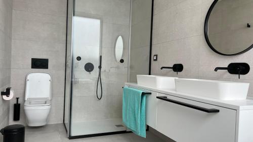 a bathroom with two sinks and a shower and a toilet at Luxurious villa with ocean views in Callao Salvaje