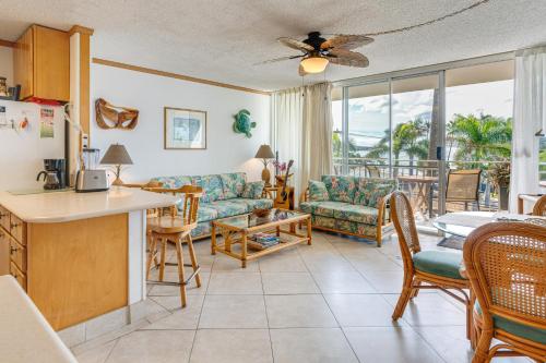 a living room with a couch and a table at Condo with Private Lanai, Ocean View and On-Site Pool! in Kihei