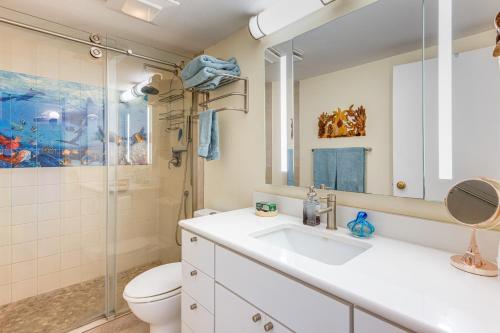 a bathroom with a sink and a toilet and a shower at Condo with Private Lanai, Ocean View and On-Site Pool! in Kihei