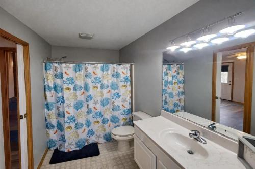 a bathroom with a toilet and a shower curtain at KH4112-Resting Beach Face in Kitty Hawk