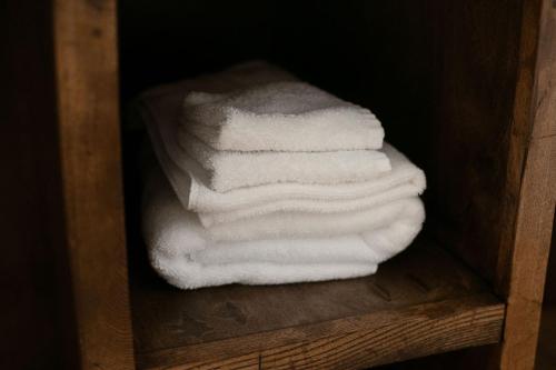 a stack of white towels sitting on a wooden shelf at New Field Farm at Timber Ridge in Lexington