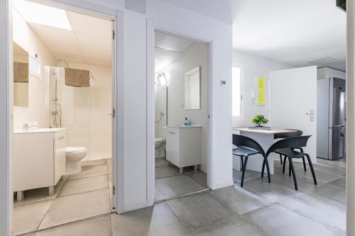 a bathroom with a table and a toilet and a sink at Coliving San Esteban in La Ñora