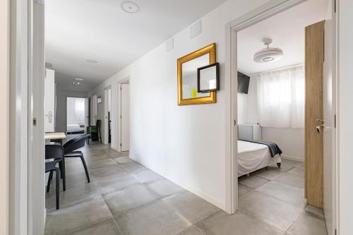 a corridor of a hotel room with a bed and a desk at Coliving San Esteban in La Ñora