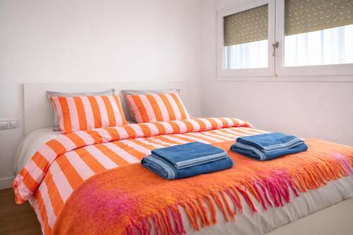 a bedroom with a bed with two towels on it at Beachfront apartment with sea views in Cunit