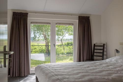 Llit o llits en una habitació de De Gemoedelijkheid
