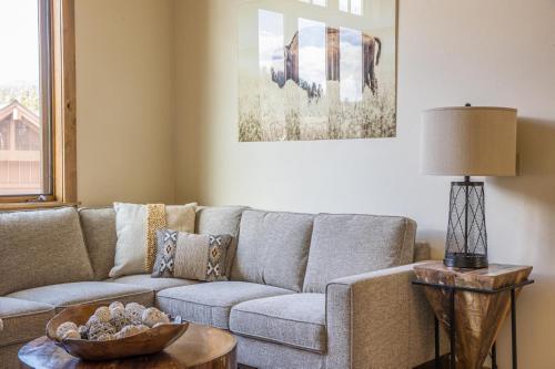 a living room with a couch and a table at Alpenglow Condo 36A in Big Sky