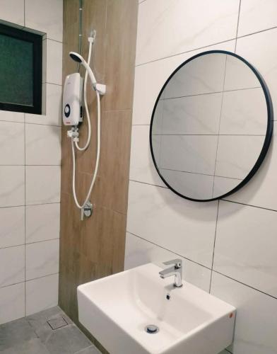 a bathroom with a sink and a mirror at Piccadilly Residence by LMS ipoh in Ipoh