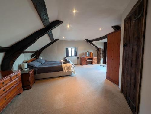 a bedroom with a bed and a dresser in a room at The Farmhouse in Teignmouth