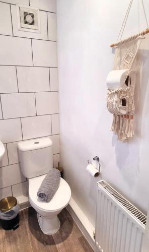 a bathroom with a white toilet in a room at Sleepy Snug in Swansea
