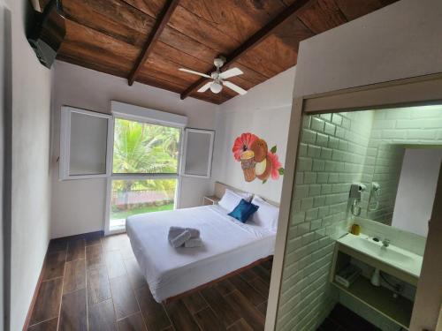 a bedroom with a bed and a window and a sink at Basi Resort in Nombre de Dios