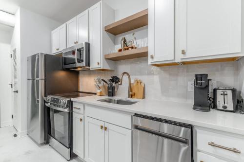 a kitchen with white cabinets and stainless steel appliances at Park Hotel Studio Suite 307 in Chattanooga