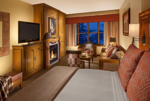 a hotel room with a bed and a fireplace at Faraway Jackson Hole in Teton Village