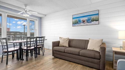 a living room with a couch and a table at Beachfront WW Crest Condo Sleeps 6 in Wildwood Crest