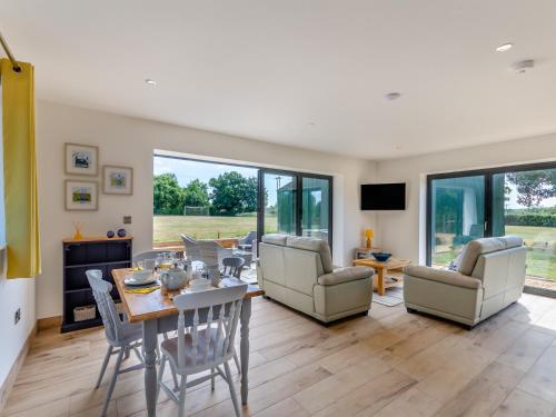 a living room with a table and chairs at Cathill Cottage in Creech Saint Michael