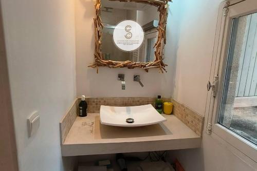 a bathroom with a sink and a mirror at Coté Nature Arles Centre in Arles