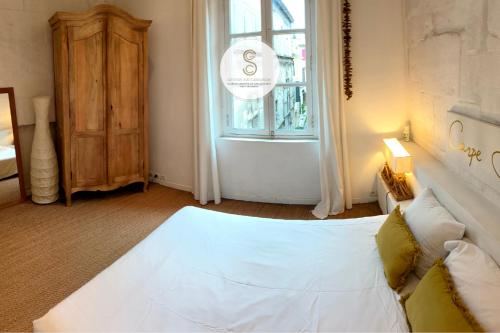 a bedroom with a white bed and a window at Coté Nature Arles Centre in Arles