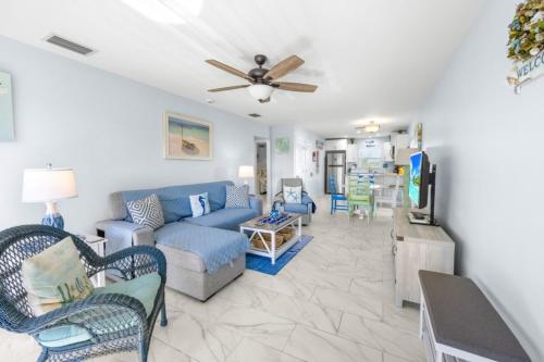 a living room with a blue couch and chairs at Seashells Unit 44 in Sanibel