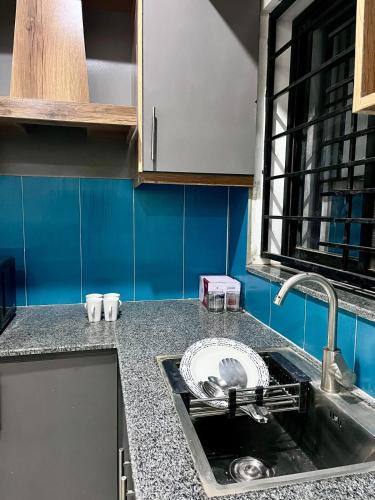 a kitchen with a sink and a counter top at Livora stays Cozy Luxury 1BHK in Multan