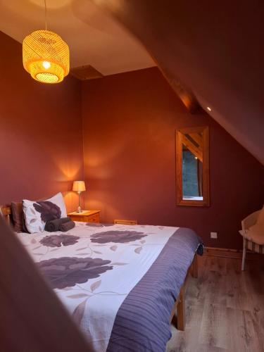 a bedroom with a large bed in a room at Les Marronniers Gîtes in Crozant