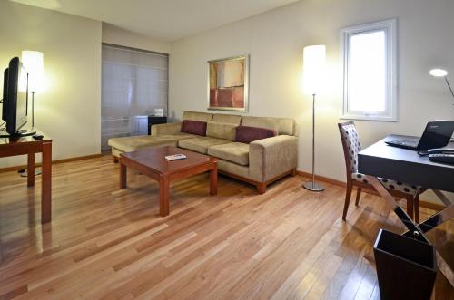 a living room with a couch and a table at Grand Brizo Comahue in Neuquén