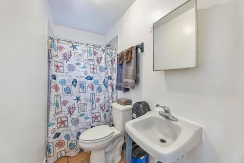 a bathroom with a toilet and a sink at Charming Studio by Sandy Beach - Affordable & Private in Rincon