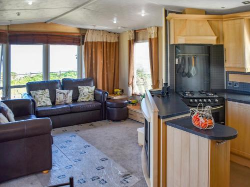a kitchen and living room of a caravan at Sea View in Trimingham