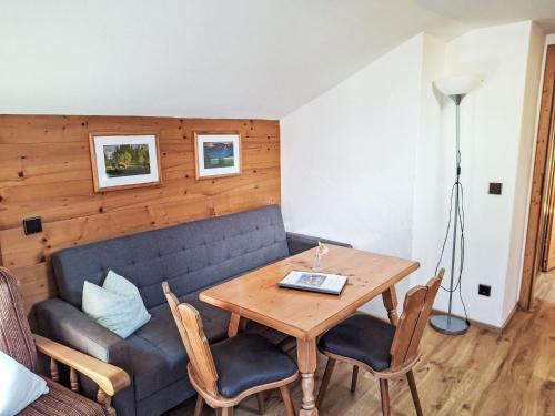 a living room with a table and a couch at Apartment Kramer by Interhome in Farchant