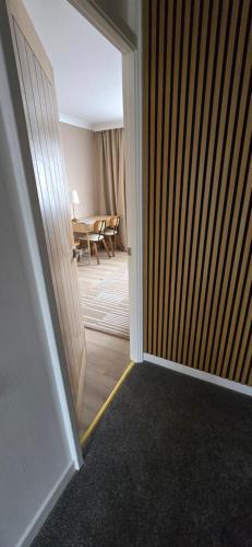 an open door to a room with a dining room at Twickenham and West Middlesex Rooms Isleworth Stay in Isleworth