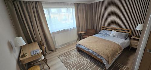 a bedroom with a bed and a large window at Twickenham and West Middlesex Rooms Isleworth Stay in Isleworth